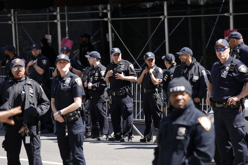 Police gather outside the courthouse, where Mr Trump will be arraigned. Getty / AFP