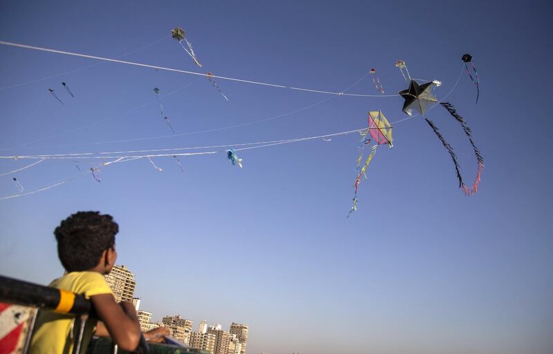 A boy prepares to fly a kite on a bridge over Nile River in Cairo, Egypt. EPA