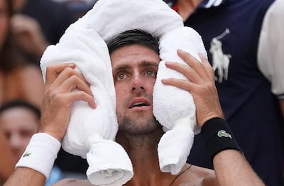 TOPSHOT - Novak Djokovic of Serbia cools off against Joao Sousa of Portugal  during their 4th round 2018 US Open Men's Singles match at the USTA Billie Jean King National Tennis Center in New York on September 3, 2018. (Photo by TIMOTHY A. CLARY / AFP)