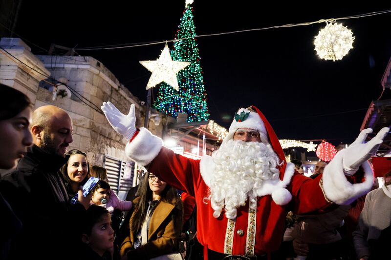 Santa Claus attends a Christmas tree lighting ceremony in Jerusalem's Old City. Reuters