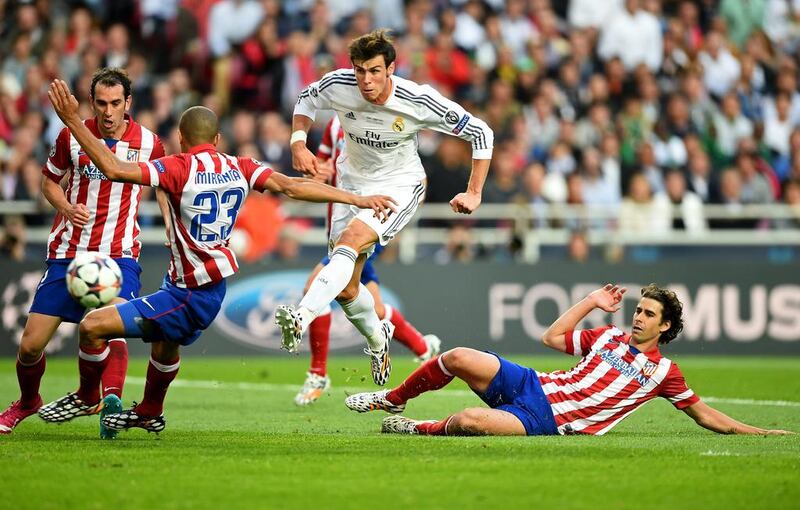 Gareth Bale had two of Real Madrid’s best chances before netting the second. Here he shoots wide of the goal under pressure from Atletico’s Miranda and Tiago during the Uefa Champions League Final at Estadio da Luz on May 24, 2014 in Lisbon, Portugal. Photo by Laurence Griffiths / Getty Images