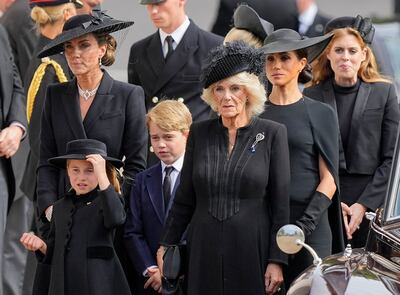 Kate, Princess of Wales, outside Westminster Abbey following the queen's funeral service with Princess Charlotte, Prince George, Queen Consort Camilla, Meghan, Duchess of Sussex, and Princess Beatrice. AP