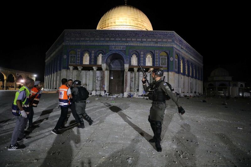 An Israeli police officer scuffles with a Palestinian man in front of the Dome of the Rock shrine at Haram Al Sharif – the Al Aqsa Mosque compound – in Jerusalem. Reuters
