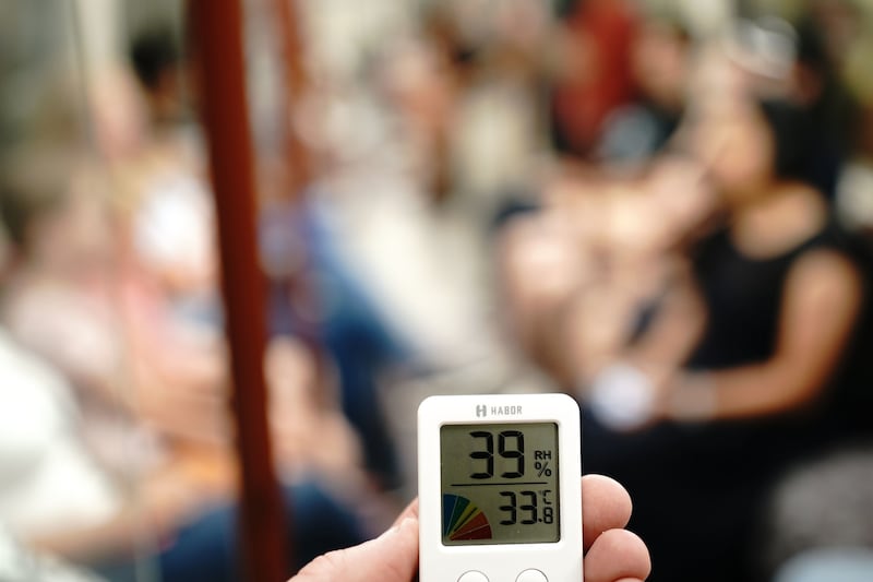 A digital thermometer displaying a temperature of 39°C on a London Underground train. PA