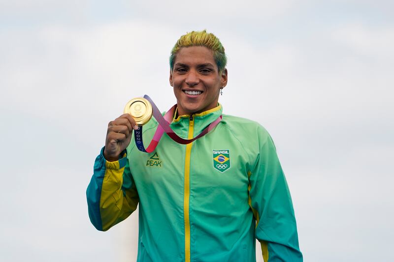 Ana Marcela Cunha, of Brazil, poses with her gold medal during a victory ceremony for the women's marathon swimming event.