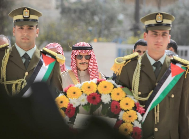 Saudi Prince Al Waleed Bin Talal lays a wreath at the grave of former Palestinian leader Yasser Arafat during an official visit to the West Bank city of Ramallah on March 4, 2014. The billionaire is in the Israeli-occupied West Bank for a meeting with Palestinian president Mahmud Abbas. Abbas Momani / AFP photo
