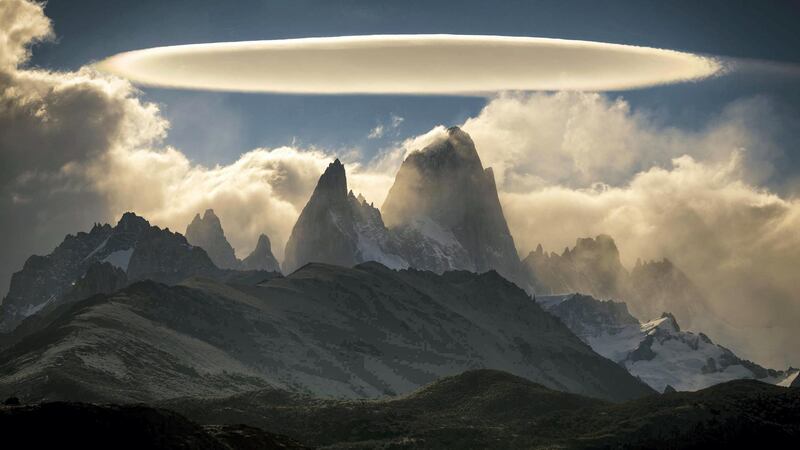 'El Chalten,' Francisco Javier Negroni Rodriguez: 'An hour before taking this photograph I was walking along the trails that surround the beautiful rock formation known as El Chalten in Argentina, the day was very cloudy... the climate in Patagonia is somewhat unpredictable, it changes every moment and the wind is so strong that it quickly moves the clouds. Only at times could the figure of the massif be distinguished. My hope was getting to a place from where I could wait very patiently for the weather to help me and give me a window of good weather at sunset to be able to take some photos, but nature surprised me... It was incredible! Only for a moment the clouds allowed me to see El Chalten and to my surprise there was a spectacular and brilliant lenticular cloud with a beautiful and perfect figure that I had never seen. It was a unique and unrepeatable gift that sometimes reminds me of how lucky I am to be a photographer and to be able to visit different places to show the world these natural and climatic beauties.'