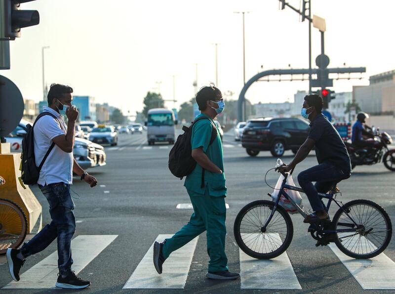 Abu Dhabi, United Arab Emirates, March 7, 2021. Pedestrians cross the street at central Abu Dhabi on a hazy afternoon.
one of the students who has taken the course 
Victor Besa / The National
Section:  NA
For:  Stock Covid/Weather