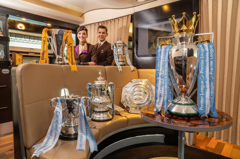 Etihad Airways staff with the six trophieds won collectively by Manchester City's men's and women's teams in 2018/19. Handout photo