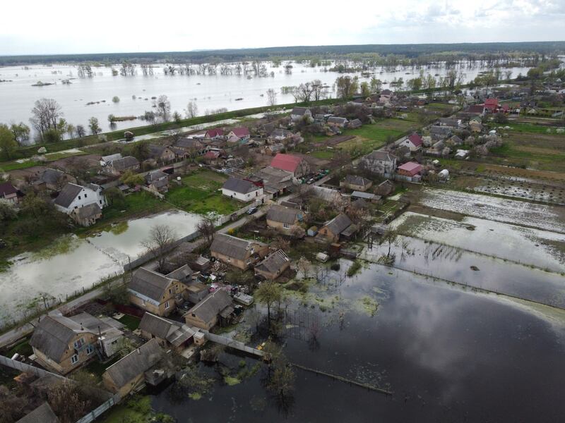 Floodwater edges towards homes in the small Ukrainian town of Demydiv. AFP