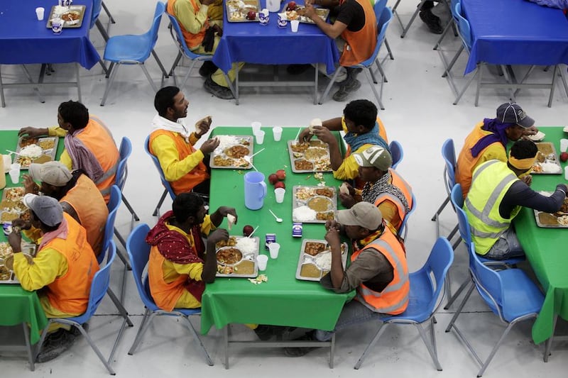 Workers sit down for lunch at the mess hall during their mid-shift break. Christopher Pike / The National