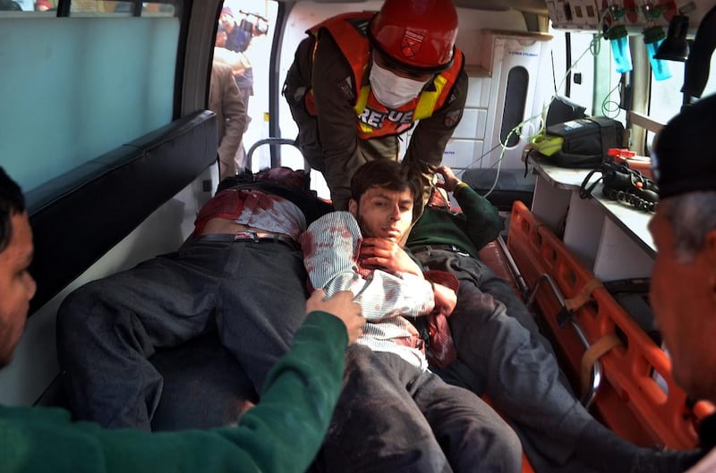 Pakistani rescue workers take out students from an ambulance who were injured in the shootout at a school under attack by Taliban gunmen, upon arrival at a local hospital in Peshawar. Mohammad Sajjad / AP Photo
