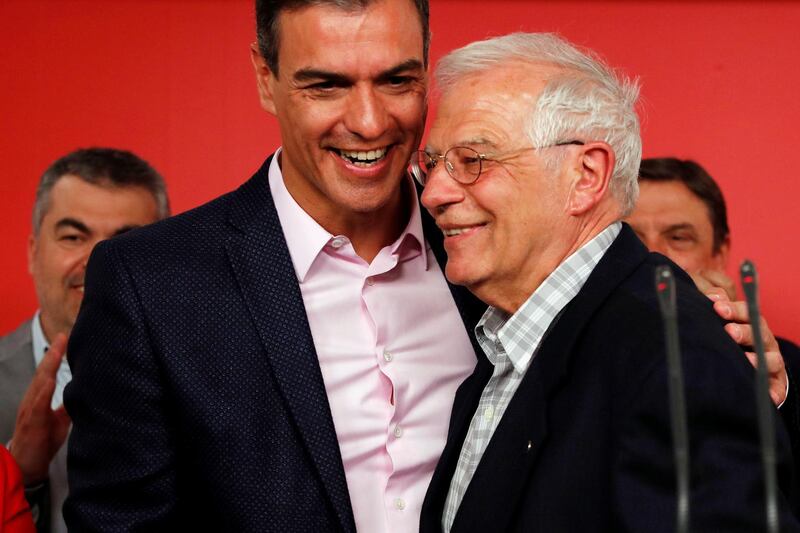 Socialist party (PSOE) candidate Josep Borrell and Spanish acting Prime Minister Pedro Sanchez embrace as they address the media in Madrid, Spain. Reuters