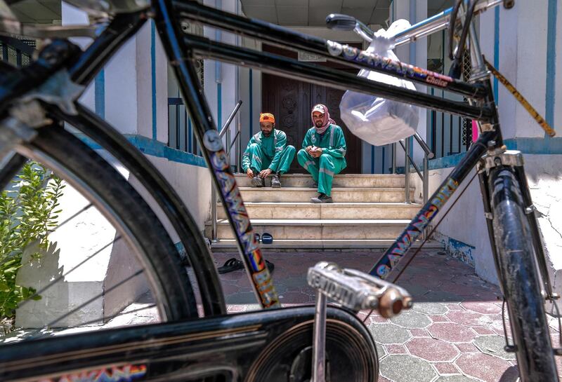 Abu Dhabi, United Arab Emirates, June 15, 2019.  
The UAE's mandatory midday break for people working outdoors during the summer months will come into force on Saturday. --  Workers find time for prayer at the Abdullah Abbas Ismail Mosque during midday break.
Victor Besa/The National
Section:  NA
Reporter: