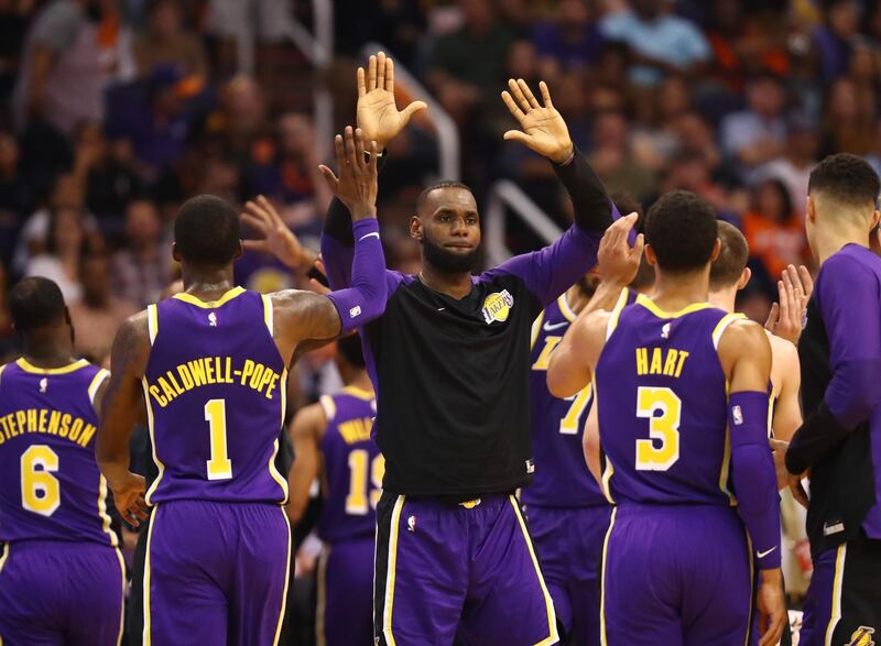 Oct 24, 2018; Phoenix, AZ, USA; Los Angeles Lakers forward Lebron James (center) celebrates with teammates against the Phoenix Suns in the second half at Talking Stick Resort Arena. Mandatory Credit: Mark J. Rebilas-USA TODAY Sports