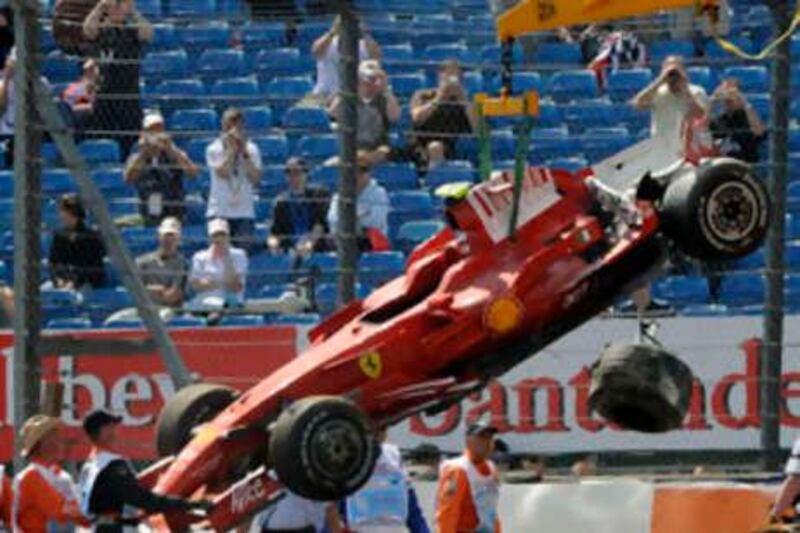 The car of Ferrari Formula One driver Felipe Massa of Brazil is loaded on to a truck after crashing at Stowe corner at the Silverstone race track ahead of the British F1 Grand Prix in central England July 4, 2008.    REUTERS/ Eddie Keogh (BRITAIN) *** Local Caption ***  EDY03_SPORT-RACING-_0704_11.JPG