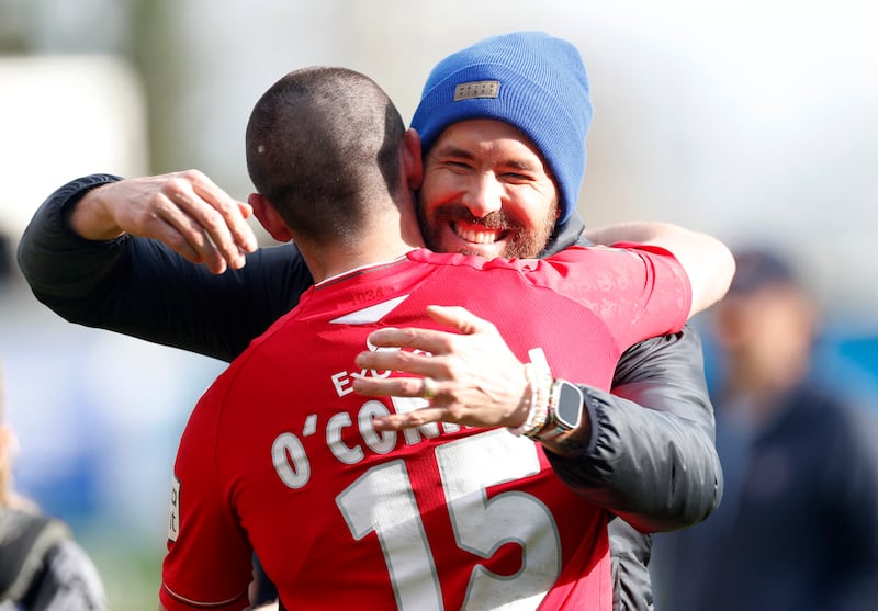 Wrexham co-owner Ryan Reynolds celebrates with Eoghan O'Connel. Reuters