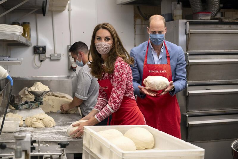 LONDON, ENGLAND - SEPTEMBER 15: Prince William, Duke of Cambridge and Catherine, Duchess of Cambridge knead dough during a visit to Beigel Bake Brick Lane Bakery on September 15, 2020 in London, England. The 24-hour bakery was forced to reduce their opening hours during the pandemic and The Duke and Duchess heard how this affected employees, as well as the ways in which the shop has helped the local community through food donation and delivery. (Photo by Justin Tallis - WPA Pool/Getty Images)