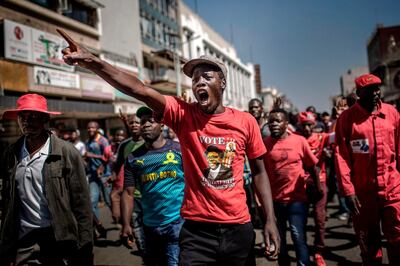 TOPSHOT - Supporters of the opposition party Movement for Democratic Change (MDC), protest against alleged widespread fraud by the election authority and ruling party, after the announcement of election's results, in the streets of Harare, on August 1, 2018.
Zimbabwe's ruling ZANU-PF party won the most seats in parliament, official results showed on August 1, 2018, but EU observers criticised the Zimbabwe elections for being held on an "un-level playing field". / AFP PHOTO / Luis TATO