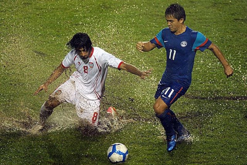 The conditions at least suited UAE's tough tackling Hamdan Al Kamali, left, as he tries to get the ball off India's Sunil Chhetri.

Manan Vatsyayana / AFP