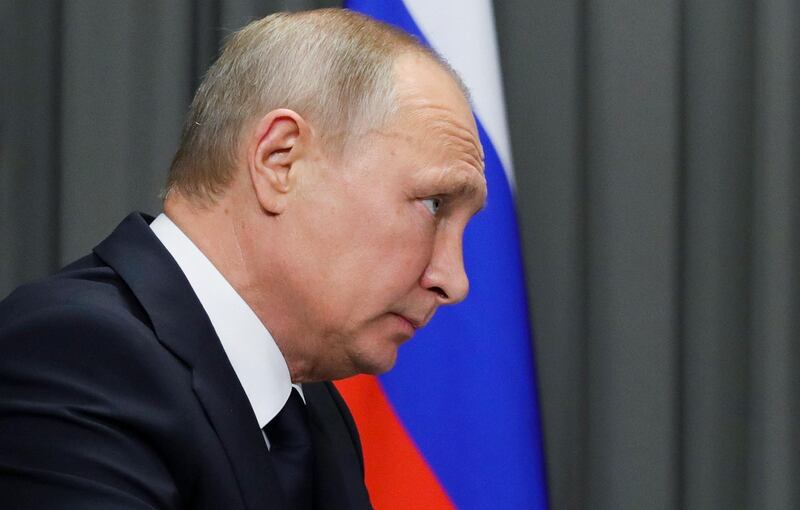 Russian President Vladimir Putin listens to local official after his meeting with workers of the GAZ factory in Nizny Novgorod, Russia, Wednesday, Dec. 6, 2017. Putin says he will seek re-election in next March's election. (Mikhail Klimentyev, Sputnik, Kremlin Pool Photo via AP)