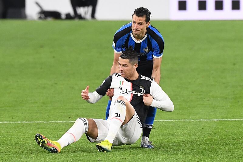 Juventus' Portuguese forward Cristiano Ronaldo is helped by Inter Milan's Italian forward Antonio Candreva. AFP