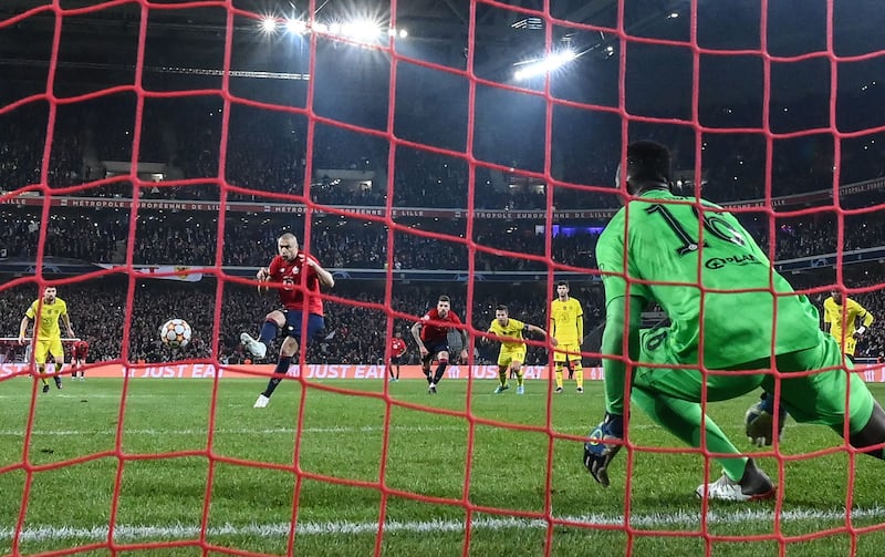 Lille's Turkish forward Burak Yilmaz scores from the penalty spot.
AFP