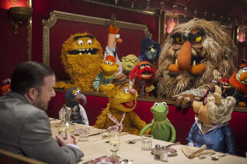Ricky Gervais, left, with the muppets in a scene from Muppets Most Wanted. Disney Enterprises, Inc., Jay Maidment / AP photo