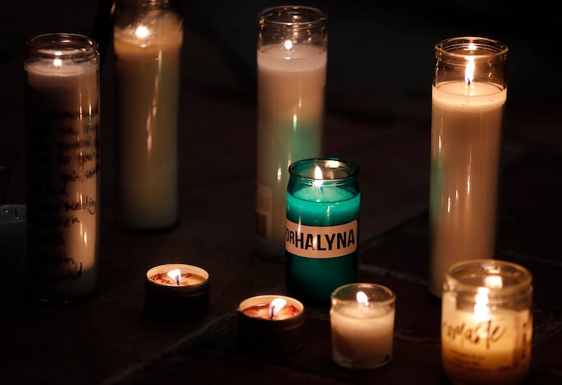 A candle bearing Halyna Hutchins's name is placed among others during a vigil in her honour. AP