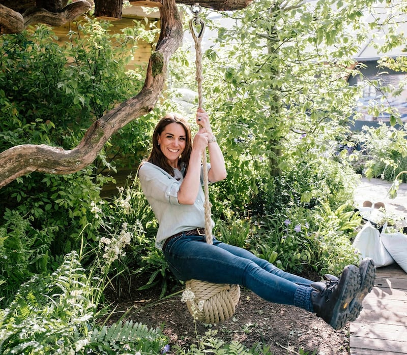 The Duchess of Cambridge wears a Jaeger linen shirt, Berghaus boots, a Mulberry belt and jeans in a photo taken in the Back To Nature garden she co-designed for the RHS Chelsea Flower Show, in London. Kensington Palace / AP