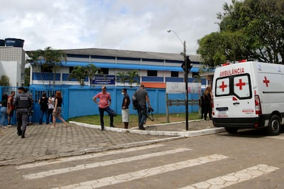 An ambulance waits outside the Primo Bitti state school after a 16-year-old former student went on a shooting spree there and at another school in Aracruz city, Brazi. AFP