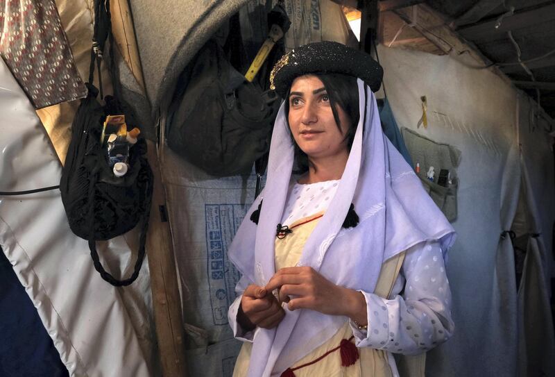 Iman Abbas, an 18-year-old Yazidi woman dressed in a traditional outfit, is pictured inside a tent at the Shaira camp for displaced people in the Simele district of the Dohuk governorate in northern Iraq, on November 21, 2019. - Abbas who was repeatedly sold as a "slave" by jihadists, recently returned from Mumbai, where she received the prestigious Mother Teresa Memorial Award on behalf of the region's Yazidi Rescue Office, with whom she works. (Photo by SAFIN HAMED / AFP)