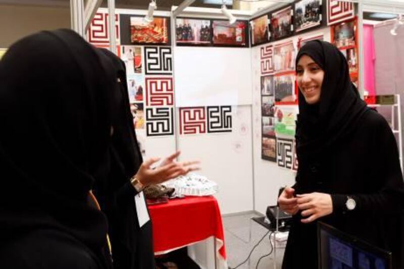 Dubai, 22nd February 2011.  Hajer Tariq Al Khanji (22 years old of UAE University in Al Ain) gestures with other students, during the student's union of various universities campaign, held at Youth Medical Centre.  (Jeffrey E Biteng / The National)  Editor's  Note;  Subject was too shy to be photographed, she needs other students to make her relax and will oblige for the photo shoot.