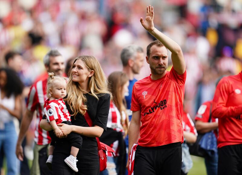 Brentford's Christian Eriksen applauds the fans during a lap on honour, with partner Sabrina Kvist Jensen and their daughter. AP