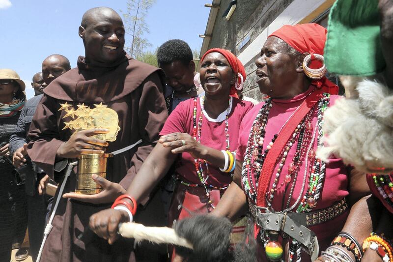 Peter Mokaya Tabichi a Kenyan science teacher and Franciscan friar at the Keriko Mixed Day Secondary School in Pwani Village of Njoro,  Nakuru County,  located 185 km from the capital city of Nairobi in Kenya celebrate with Gilgil Nyakinyua Traditional Women Group on the 30th March 2019 during his home coming reception.  Tabichi won the Global teacher award last week. Photo/Fredrick Omondi/Kenya