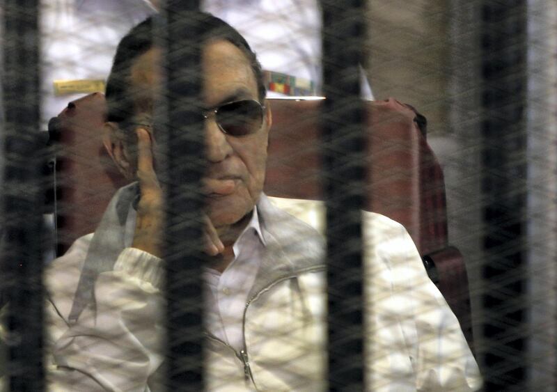 Egypt's ousted President Hosni Mubarak sits inside a dock at the police academy, on the outskirts of Cairo June 8, 2013. Families of Egyptians killed in protests that unseated Hosni Mubarak reacted angrily in court on Saturday when a judge trying the former president over the deaths barred their lawyers from taking part in the case. Mubarak's two sons, Alaa and Gamal, were also in court on separate charges of financial corruption. REUTERS/Amr Abdallah Dalsh (EGYPT - Tags: POLITICS CIVIL UNREST CRIME LAW)