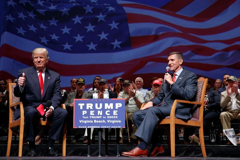 FILE - Then-presidential candidate Donald Trump gives a thumbs up as he speaks with retired Lt. Gen. Michael Flynn during a town hall, Tuesday, Sept. 6, 2016, in Virginia Beach, Va. President Donald Trump has pardoned Michael Flynn, taking direct aim in the final days of his administration at a Russia investigation that he has long insisted was motivated by political bias. Trump announced the pardon on Wednesday, Nov. 25, 2020 calling it his â€œGreat Honor.â€ (AP Photo/Evan Vucci, file)