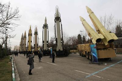 (FILES) A file photo taken on February 2, 2019 shows Iranians visiting a weaponry and military equipment exhibition in the capital Tehran, organised on the occasion of the 40th anniversary of the Iranian revolution.  A longstanding UN embargo on arms sales to and from Iran expired early on October 18, 2020, in line with a 2015 landmark nuclear deal, the Iranian foreign ministry said.
 / AFP / ATTA KENARE
