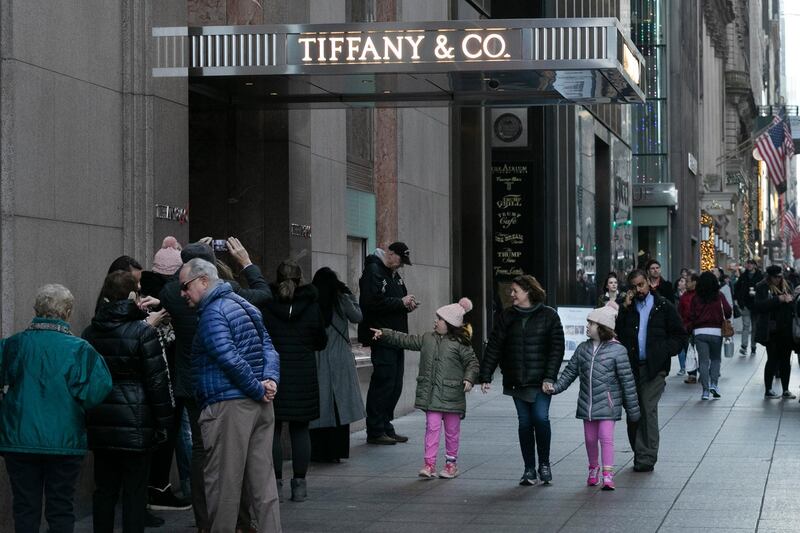 FILE - In this Nov. 25, 2019, file photo people walk by Tiffany's flagship store in New York. Tiffany & Co reports financial results on Thursday, Dec. 5. (AP Photo/Mark Lennihan, File)