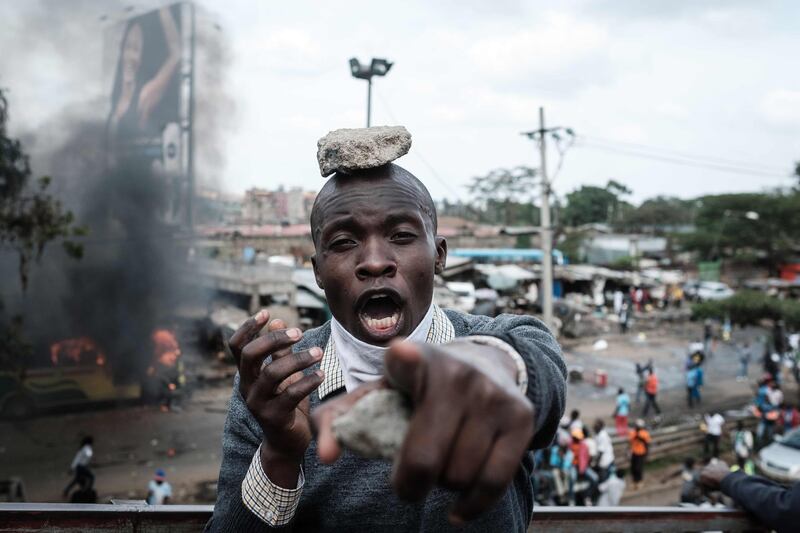 A supporter of Kenyan's opposition party National Super Alliance (NASA) reacts during a demonstration following the arrival of opposition leader Raila Odinga to the Jomo Kenyatta Internation airport. Yasuyoshi Chiba / AFP Photo