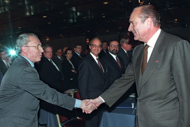 French President Jacques Chirac shakes hands with Mr Delors at the French Stocks Operations Commission, December 9, 1997. Reuters