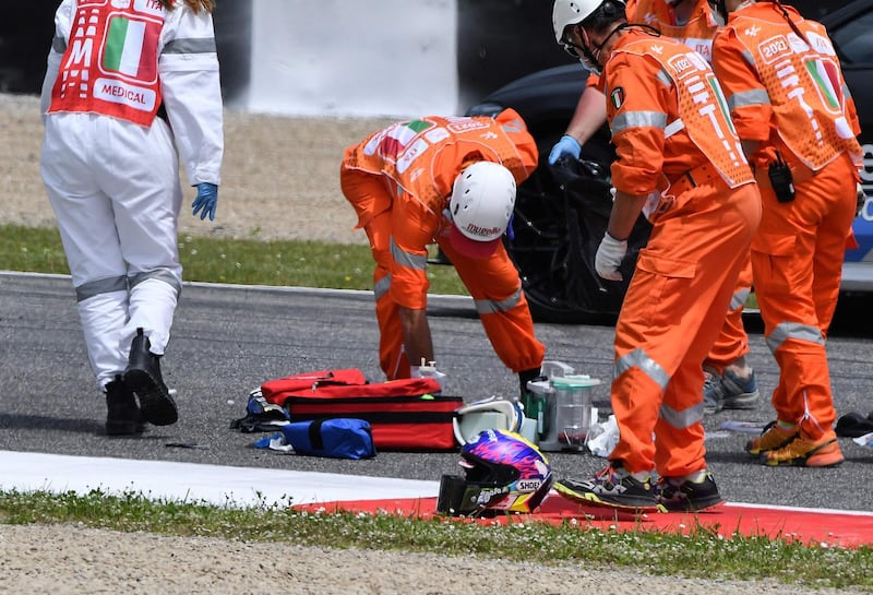 Medical officers clear the track as they evacuate Swiss Moto3 rider Jason Dupasquier in after a crash at the Mugello race track. AFP