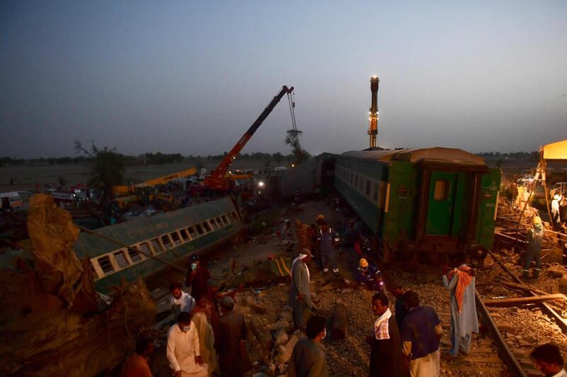 Railway workers operate at the site of the accident. AFP