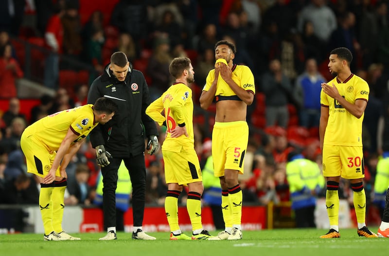Sheffield United players after the defeat at Old Trafford leaves them on the brink of relegation. Reuters