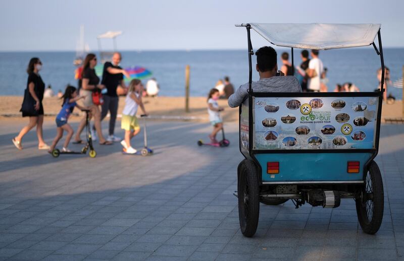 A man sits on his rickshaw waiting for clients as Spain officially reopens the borders amid the coronavirus disease outbreak, in Barcelona, Spain. Reuters