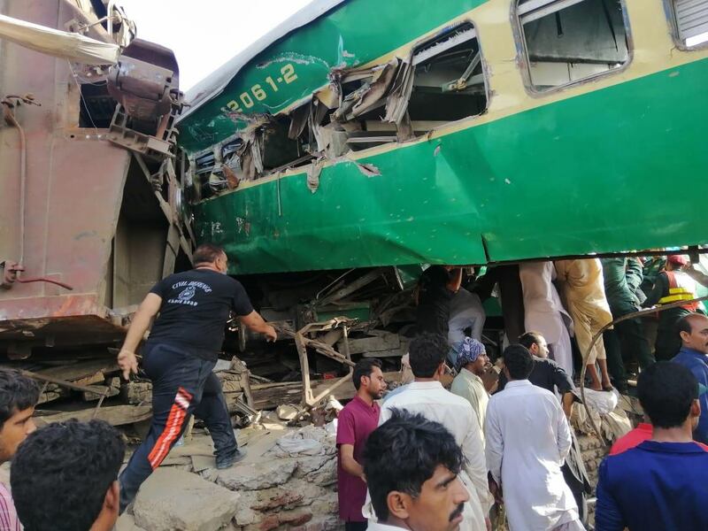 People gather at the scene of a train accident near the city of Sadiqabad in Pakistan's Punjab province on July 11, 2019.  EPA