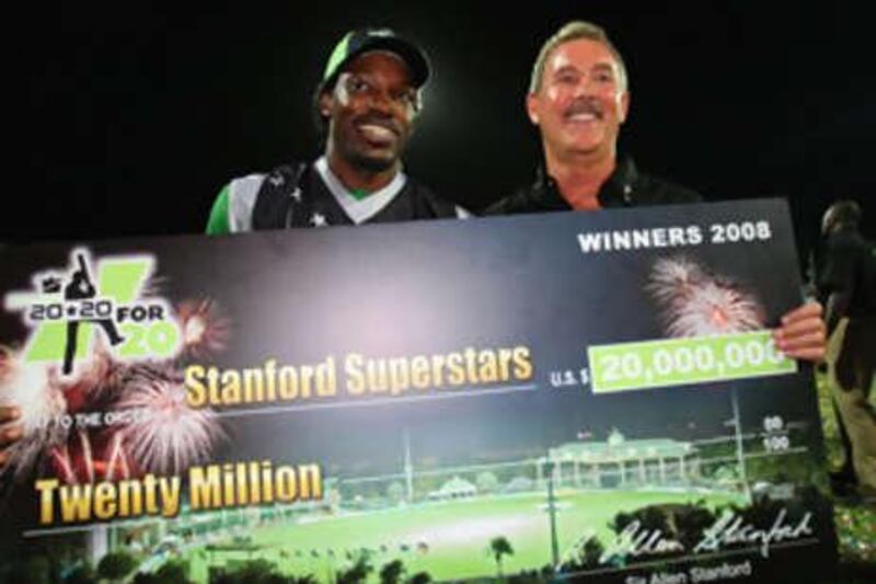Chris Gayle of the Stanford Superstars and Sir Allen Stanford pose with the cheque after the Superstars beat England in Antigua.