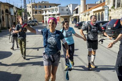 Nayla Cortas and Ali Kedami cross the finishing line at the end of the Lebanon Mountain Trail, Marjaayoun, Lebanon on Saturday May 1 2021. Matt Kynaston for The National