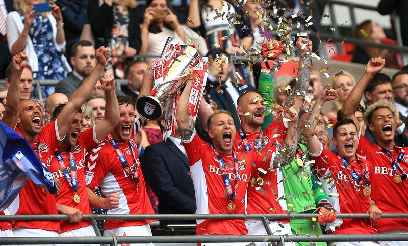 LONDON, ENGLAND - MAY 26: Jason Pearce of Charlton Athletic and Chris Solly of Charlton Athletic lift the trophy following their victory and promotion in the Sky Bet League One Play-off Final match between Charlton Athletic and Sunderland at Wembley Stadium on May 26, 2019 in London, United Kingdom. (Photo by James Chance/Getty Images)