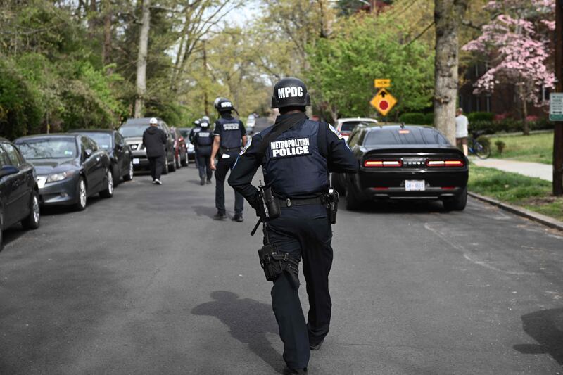 Police officers respond to news of a shooting. AFP